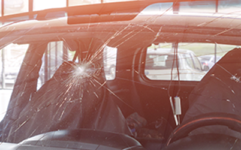 Vehicle windshield with a large impact crack spreading across the glass